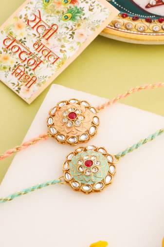 men set of 2 peach & green kundan studded round floral design rakhi with roli chawal chandan & mishri