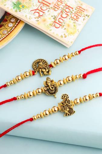   set of 3 gold toned designer ganesh ji thread rakhi with roli chawal chandan & mishri
