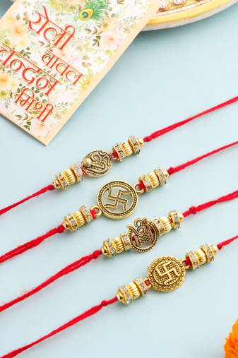   set of 4 gold toned artificial stones swastik design thread rakhi with roli chawal chandan & mishri