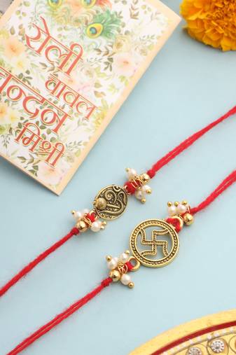   set of 2 gold toned pearls swastik desgin thread rakhi with roli chawal chandan & mishri
