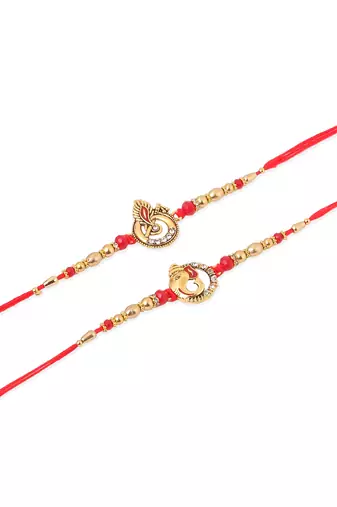   set of 2 golden red religious designer ganesh ji thread rakhi with roli chawal chandan & mishri
