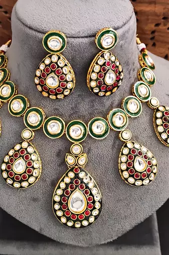 Traditional indian kundan necklace set with earrings, green enamel and ruby red stones, gold-plated
