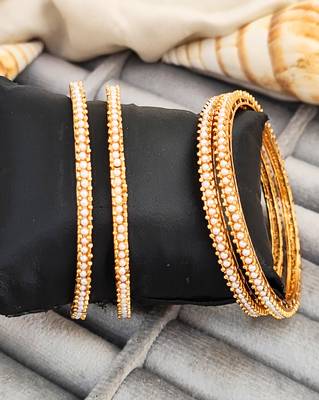 gold alloy bangles set with pearl work 1