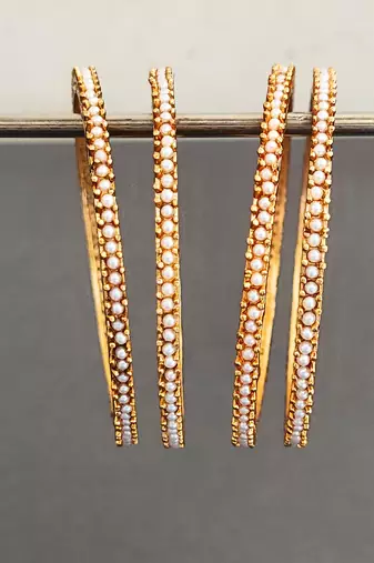 gold alloy bangles set with pearl work