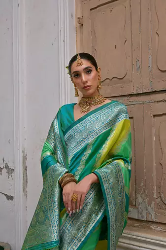 Green banarasi silk blend blend weaving saree with zari woven fancy tassels