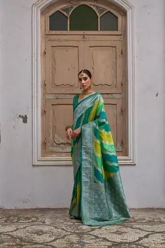 Green banarasi silk blend blend weaving saree with zari woven fancy tassels