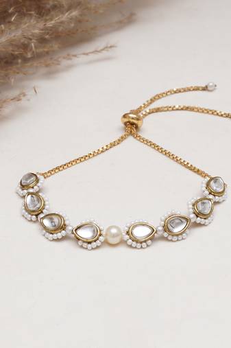 Golden tilak kundan with white pearls adjustable bracelet