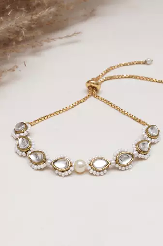 Golden tilak kundan with white pearls adjustable bracelet