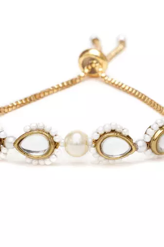 Golden tilak kundan with white pearls adjustable bracelet