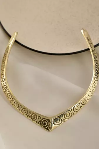 Gold plated v-shaped necklace with intricate swirl patterns for women