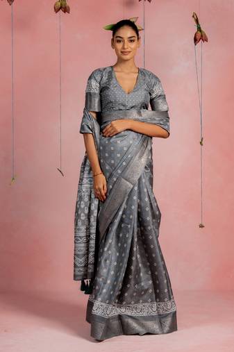 Grey silk blend block printbatik print golden zari woven border tassels saree with unstitched blouse piece
