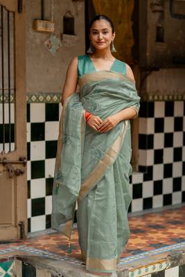 Sea green organza embroidered golden zari woven border saree with unstitched blouse piece 1