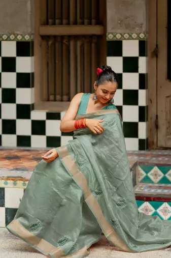 Sea green organza embroidered golden zari woven border saree with unstitched blouse piece