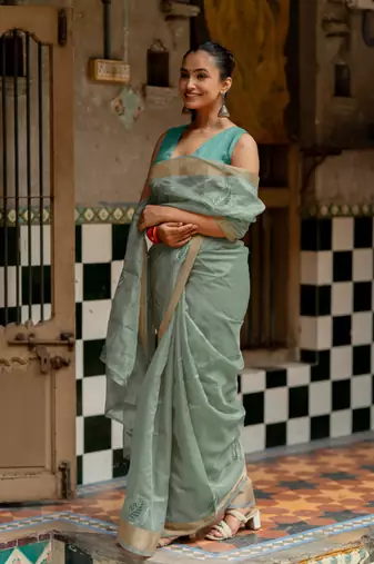 Sea green organza embroidered golden zari woven border saree with unstitched blouse piece