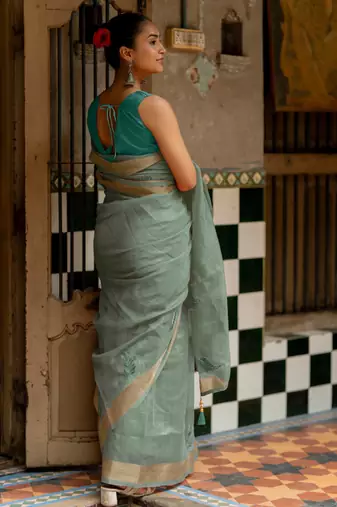 Sea green organza embroidered golden zari woven border saree with unstitched blouse piece