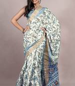 Off white silk blend abstract leaf print golden zari border saree with unstitched blouse piece