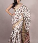 Off white silk blend abstract leaf print golden zari border saree with unstitched blouse piece