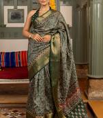 Dark green art silk ajrakh print golden zari saree with unstiched blouse piece