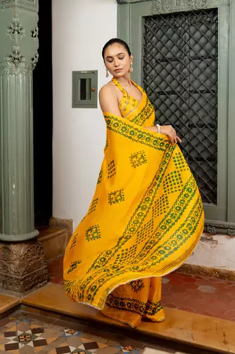 Dark yellow chiffon batik block print lace border saree with unstiched blouse piece