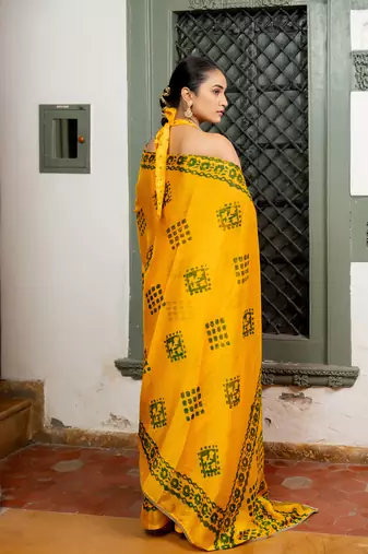 Dark yellow chiffon batik block print lace border saree with unstiched blouse piece