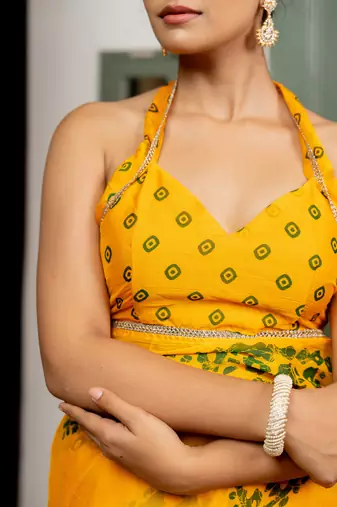 Dark yellow chiffon batik block print lace border saree with unstiched blouse piece