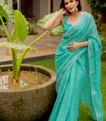 Light teal green cotton blend floral print crochet lace border saree with unstiched blouse piece