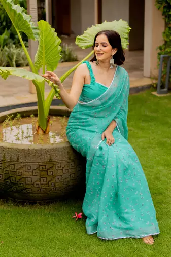 Light teal green cotton blend floral print crochet lace border saree with unstiched blouse piece