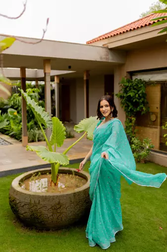 Light teal green cotton blend floral print crochet lace border saree with unstiched blouse piece