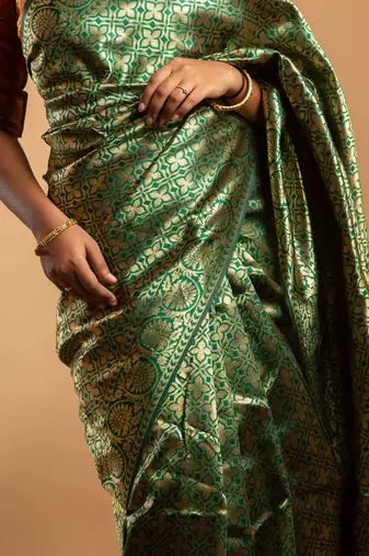 Green and red zari woven saree with floral motifs