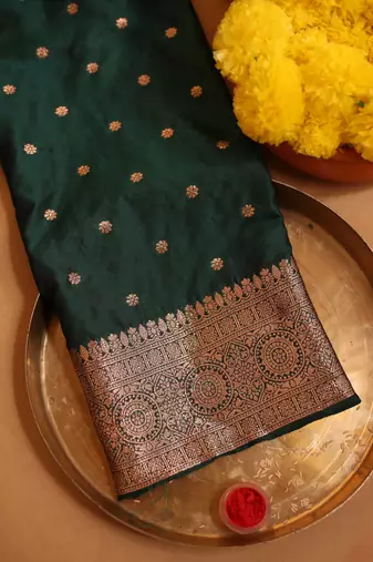 Emerald green art silk saree with zari woven leaf motifs