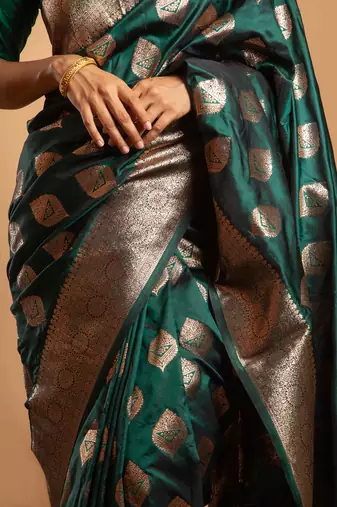 Emerald green art silk saree with zari woven leaf motifs