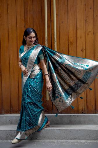 Teal green zari woven saree with floral border and tassels