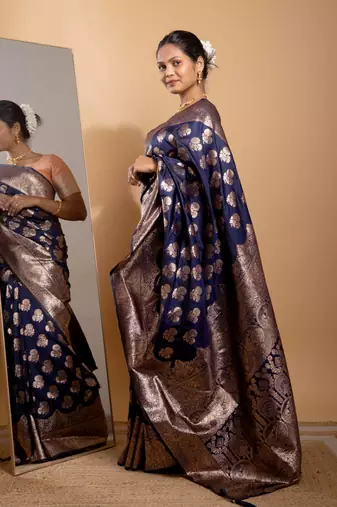 Navy blue zari woven saree with floral motifs and grand border