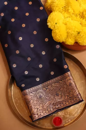 Navy blue zari woven saree with floral motifs and grand border