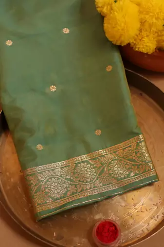 Turquoise green zari woven saree with intricate floral motifs