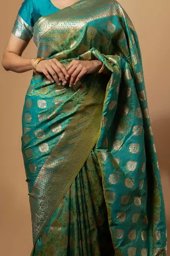 Turquoise green zari woven saree with intricate floral motifs