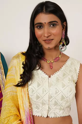 Bold red and green meenakari necklace with peacock motif earrings