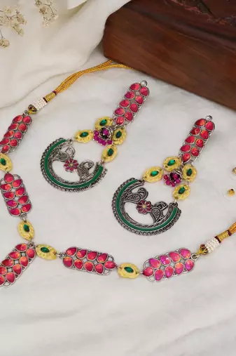 Bold red and green meenakari necklace with peacock motif earrings