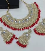 Luxurious kundan choker set with pearl and red bead accents - traditional indian bridal jewelry