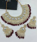 Luxurious kundan choker set with pearl and maroon bead accents - traditional indian bridal jewelry