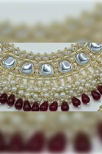 Luxurious kundan choker set with pearl and maroon bead accents - traditional indian bridal jewelry