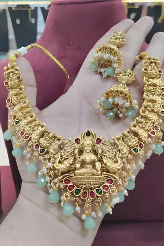 Opulent gold peacock lakshmi temple necklace set - handcrafted antique finish bridal jewelry with emerald & pearl accent