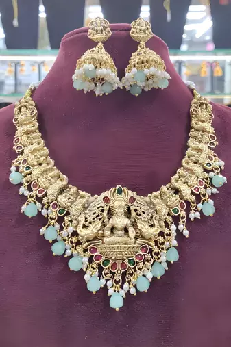 Opulent gold peacock lakshmi temple necklace set - handcrafted antique finish bridal jewelry with emerald & pearl accent