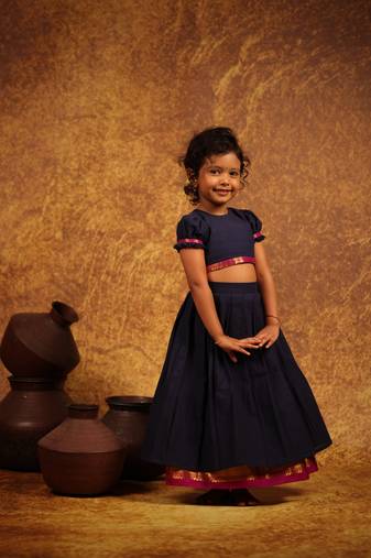 Blue crop top and skirt combo in the tradition of old pattu pavada sets.