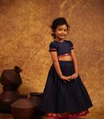Blue crop top and skirt combo in the tradition of old pattu pavada sets.