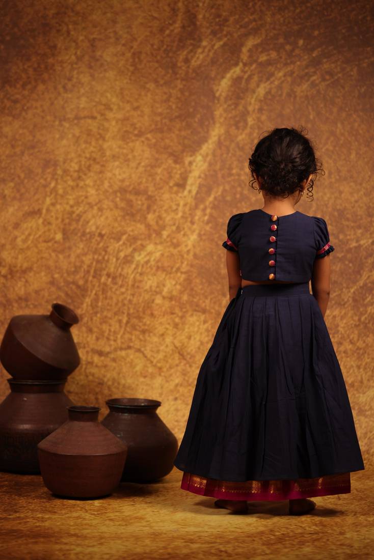 Blue crop top and skirt combo in the tradition of old pattu pavada sets.