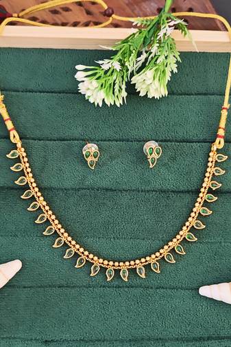 Traditional gold-plated necklace set with green stone leaf design, with delicate earrings
