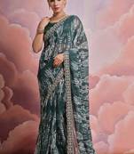 Dark green printed georgette saree with embroidered lace