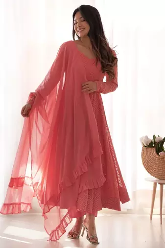 Charming pink anarkali suit with all-over embroidery, ruffled net dupatta, and matching pants   ideal for festive looks.