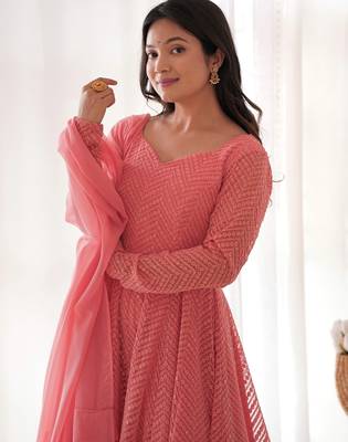 Charming pink anarkali suit with all-over embroidery, ruffled net dupatta, and matching pants   ideal for festive looks. 4